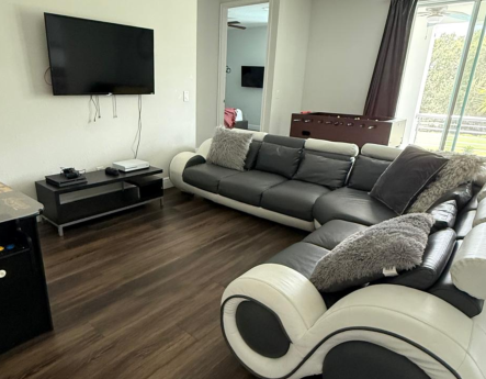 Living room with chandelier and leather seating