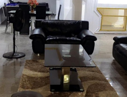 Living room with leather sofa and glass table